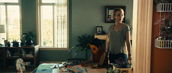 Screencap of Drive, the Rubik's cube is lying on a table.